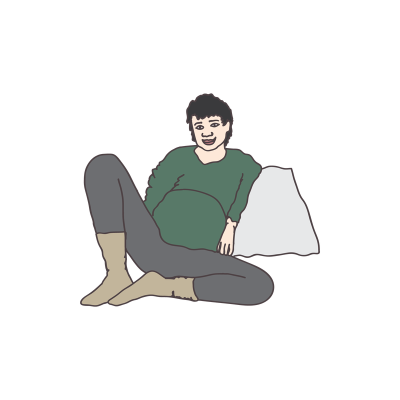 An illustration of a pregnant person in a green shirt and grey leggings reclining on a pillow.